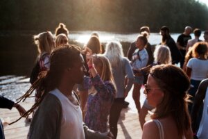 People gathered outside by some water